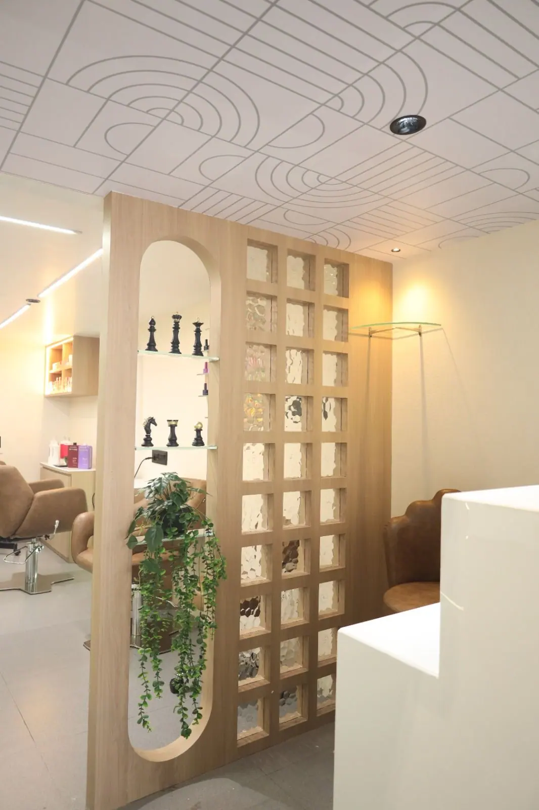 Partition — a light timber screen with glass-block grid and a display niche of planting.