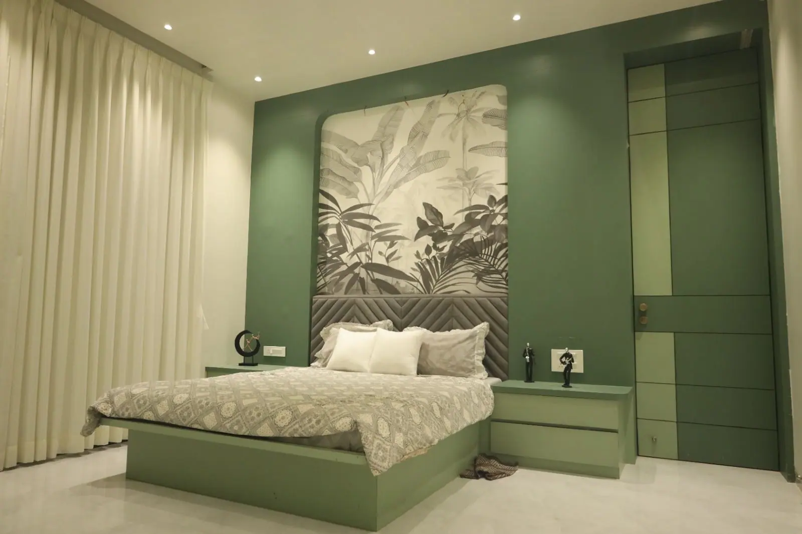 Bedroom — a botanical mural headboard framed by deep green joinery.