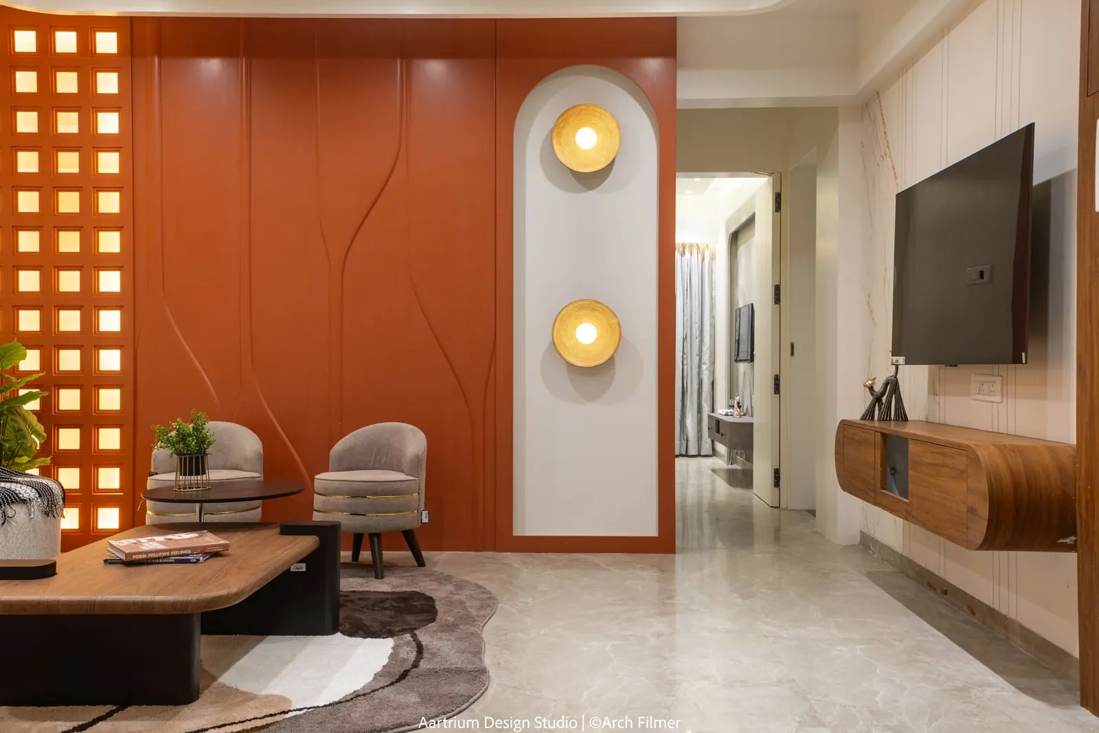 Living room — the seating group seen towards the timber TV console and passage.