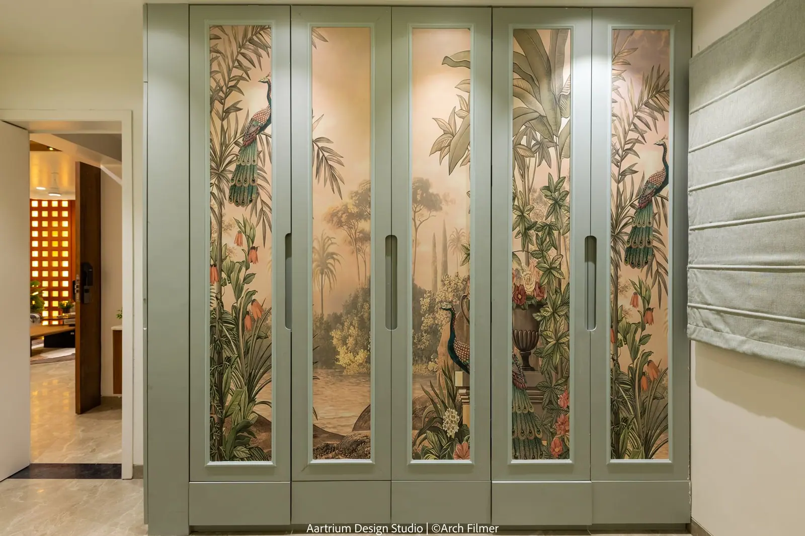 Wardrobe — sage green shutters printed with a botanical and bird mural.