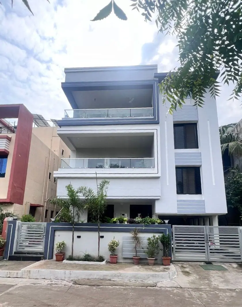 Elevation — the street facade with stacked balconies and deep parapet lines.