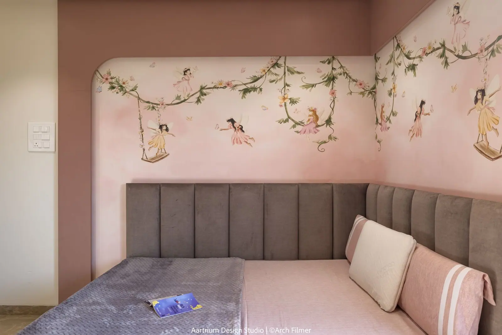 Bedroom — a hand-painted fairy mural above a channel-tufted headboard.