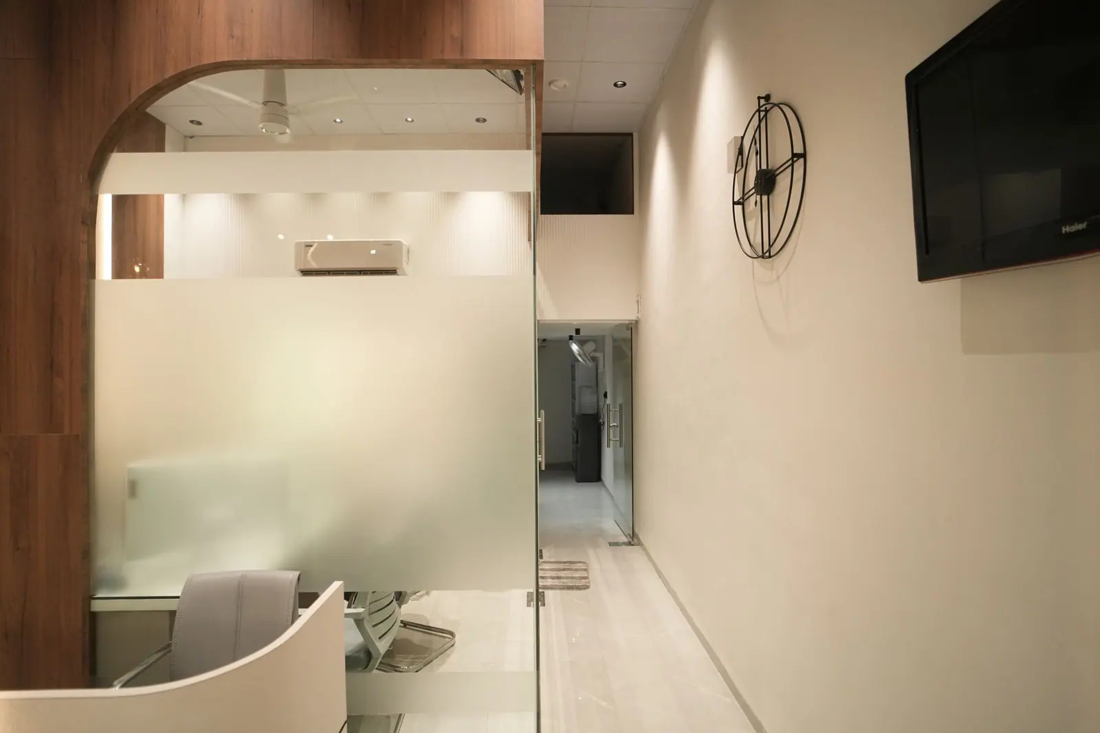 Corridor — the circulation spine between frosted glass cabins.