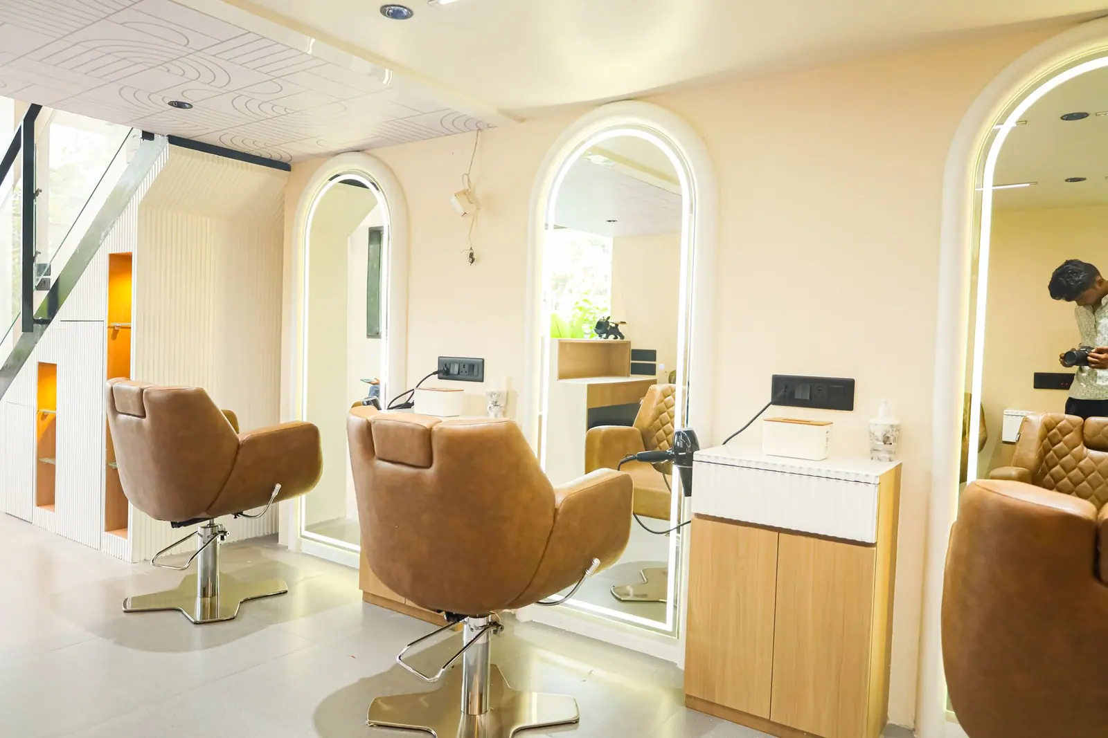 Styling floor — the full run of stations seen down the length of the salon.