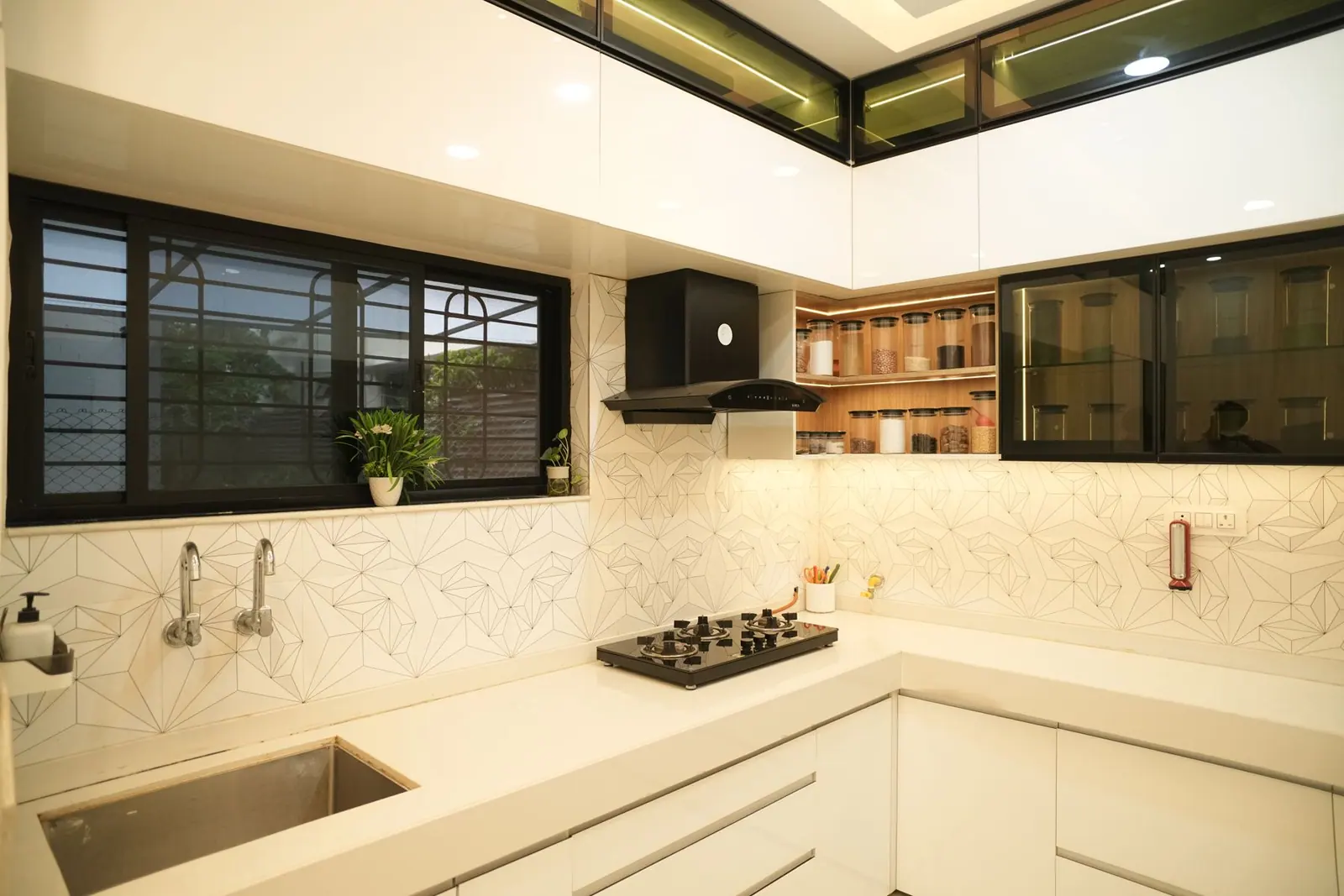 Kitchen — a white counter run with a wide window over the sink and glazed wall units.