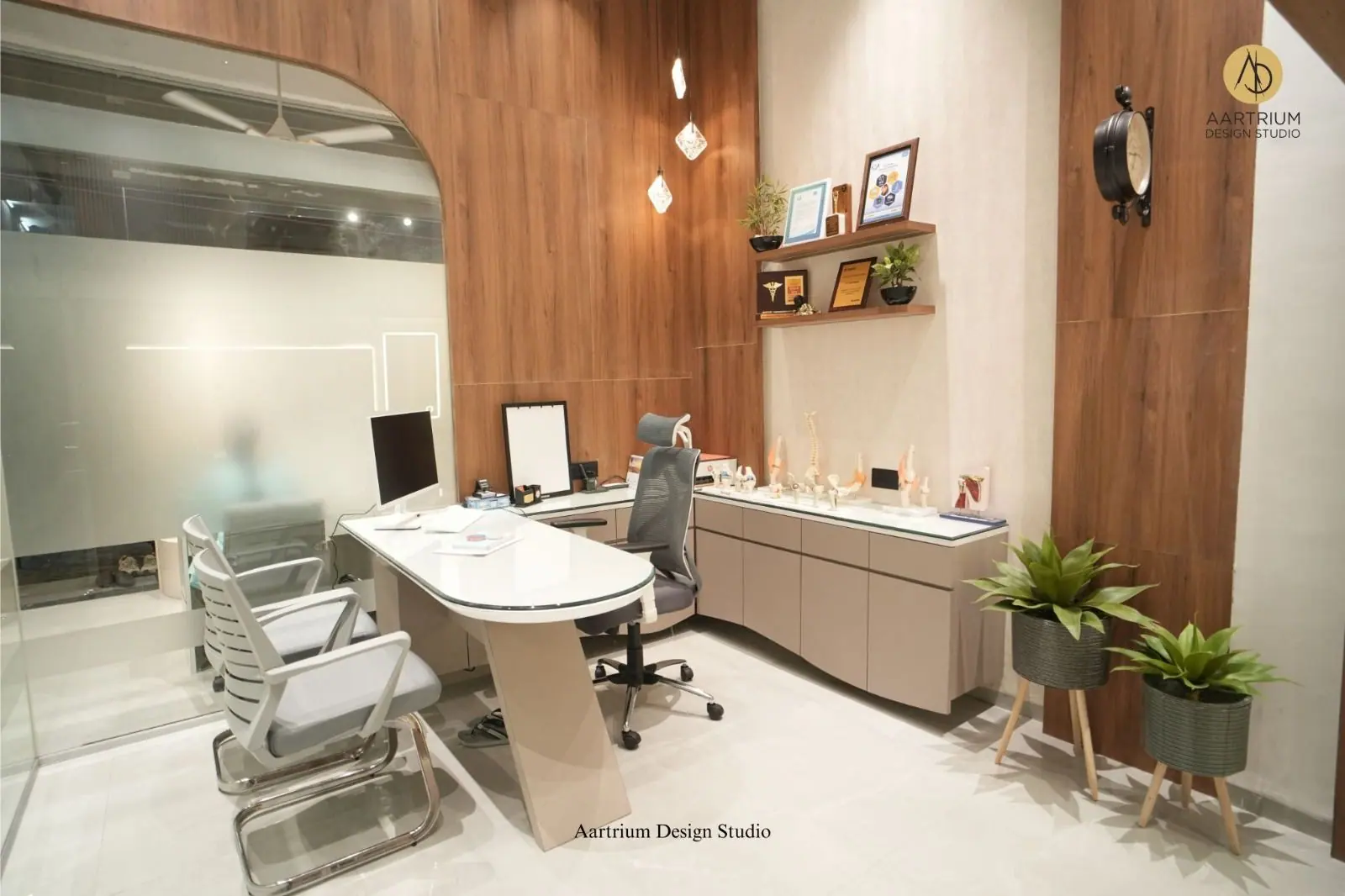 Consulting cabin — the desk with a shelf of certificates and awards on the walnut wall.